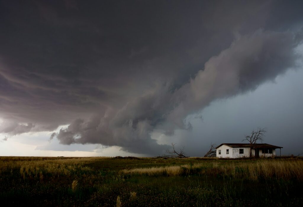 Storm approaching a home where a battery backup sump system adds protection